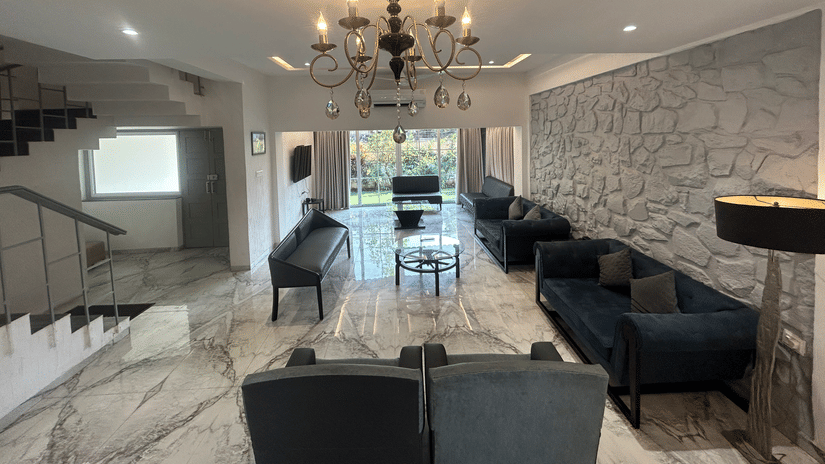 Lavish living room with a chandelier, marble flooring, and a sophisticated seating arrangement – Maxxvalue Klub Klass Villa, Lonavala.