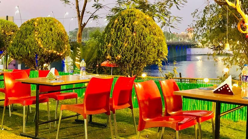 open air seating arrangement with trees next to it - VITS Kamats Resort, Silvassa