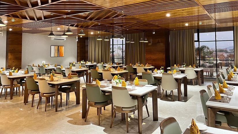 interior of a restaurant at VITS Satyajeet Karad featuring elegant seating arrangement