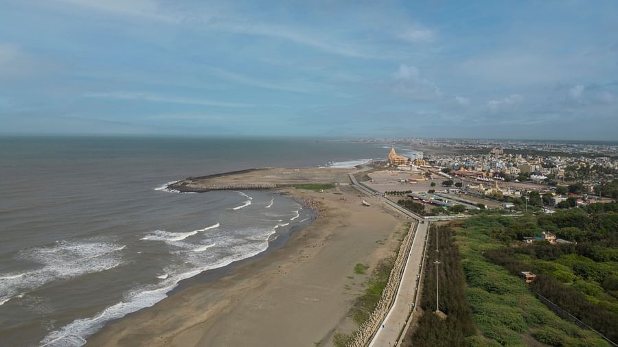 A view near Clarks Collection Somnath with waves, pathways, and urban spread along the beachside.