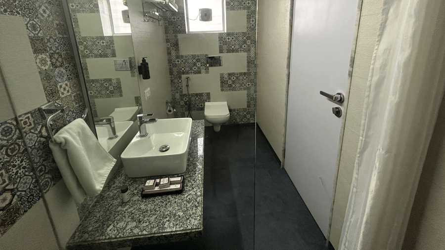 Modern bathroom with a patterned back splash, premium toiletries, and a well-lit vanity – Maxxvalue Klub Klass Villa, Lonavala.