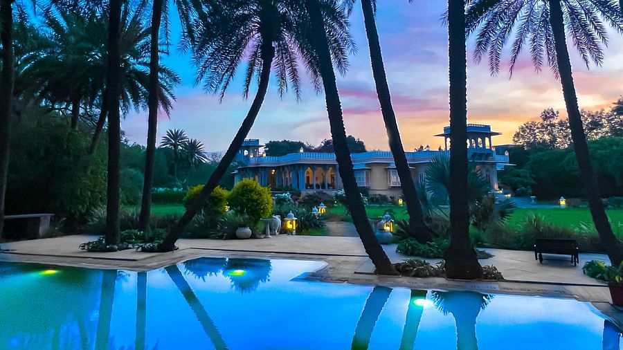 image of the swimming pool at Dev Shree, Deogarh with a picturesque background