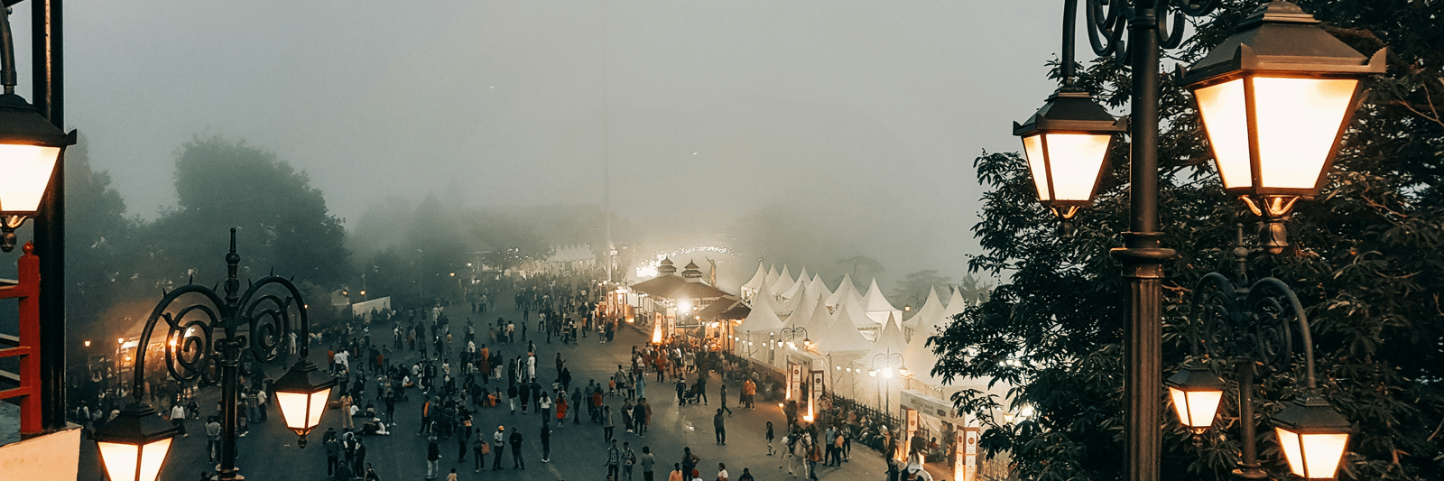 Busy street scene with mist and pedestrians, cityscape view.