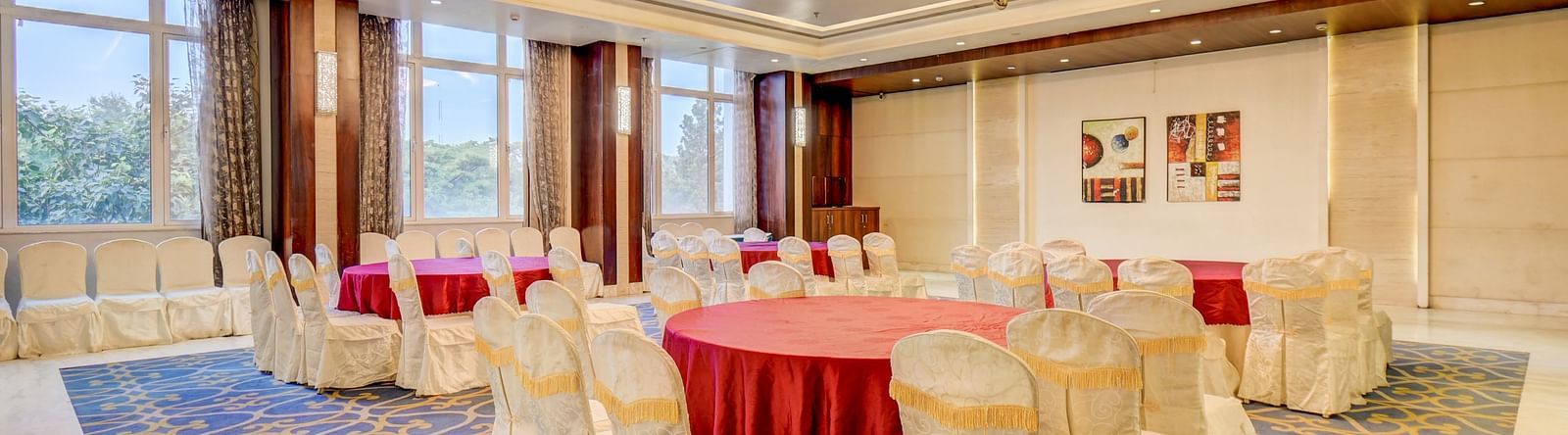 banquet hall with interior design and chairs at The SSK Solitaire Hotel & Banquets, Mumbai Naka - Nashik