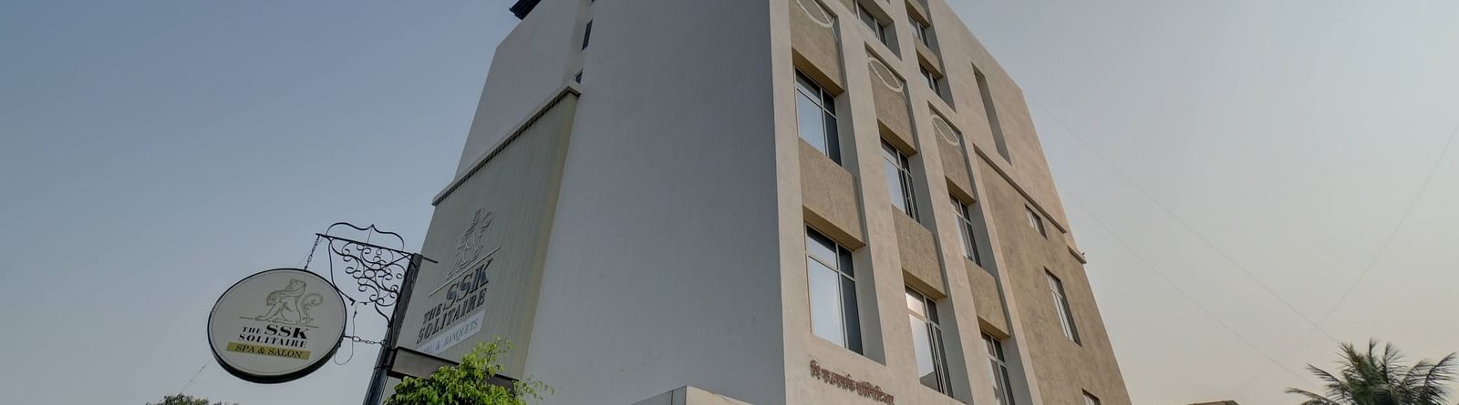 facade image of The SSK Solitaire Hotel & Banquets, Mumbai Naka - Nashik on a clear day