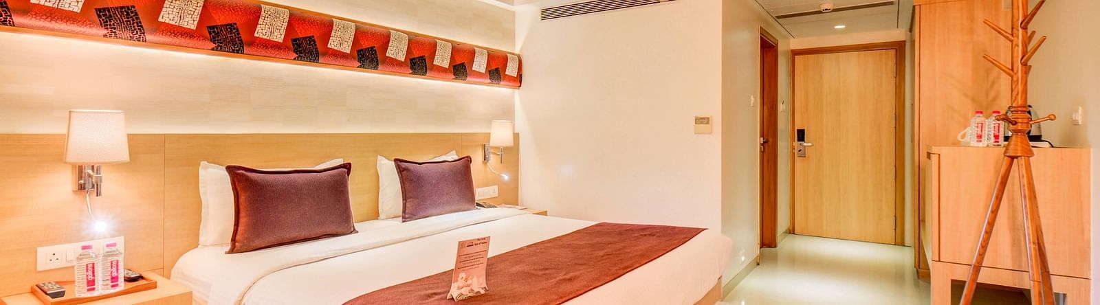 a view of the king sized bed of Deluxe room at The SSK Solitaire Hotel & Banquets, Mumbai Naka - Nashik