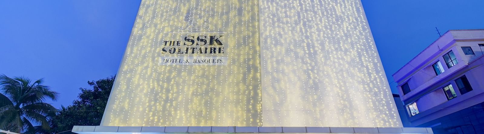 facade image of The SSK Solitaire Hotel & Banquets, Mumbai Naka - Nashik at dusk