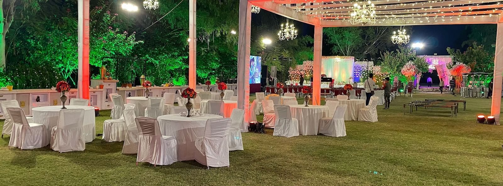 Outdoor event space with tent, tables and chairs.