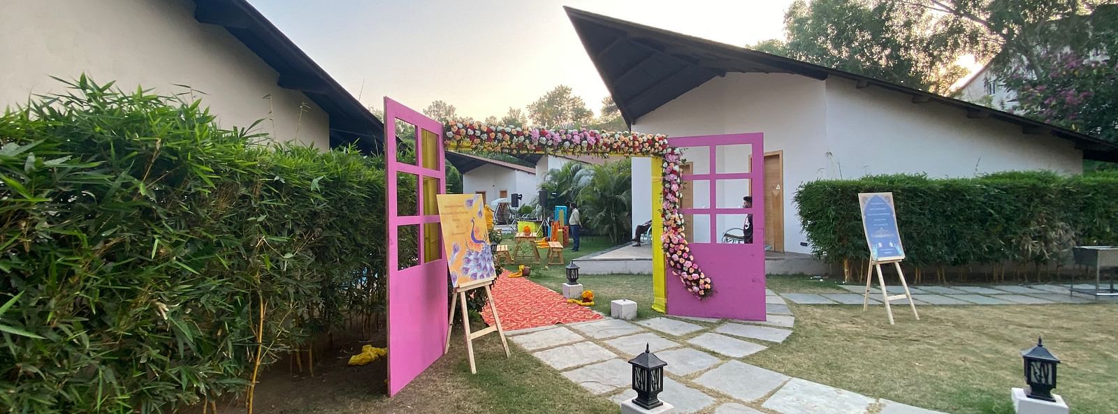 Building with walls, door, and green lawn.