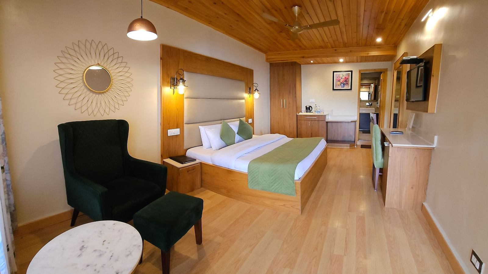 A full view of a room with bed, chair, and a coffee table | Mongas Hotel & Resort, Dalhousie