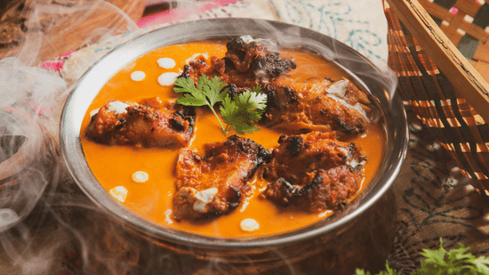 Traditional Indian curry served in a bowl with herbs and spices.