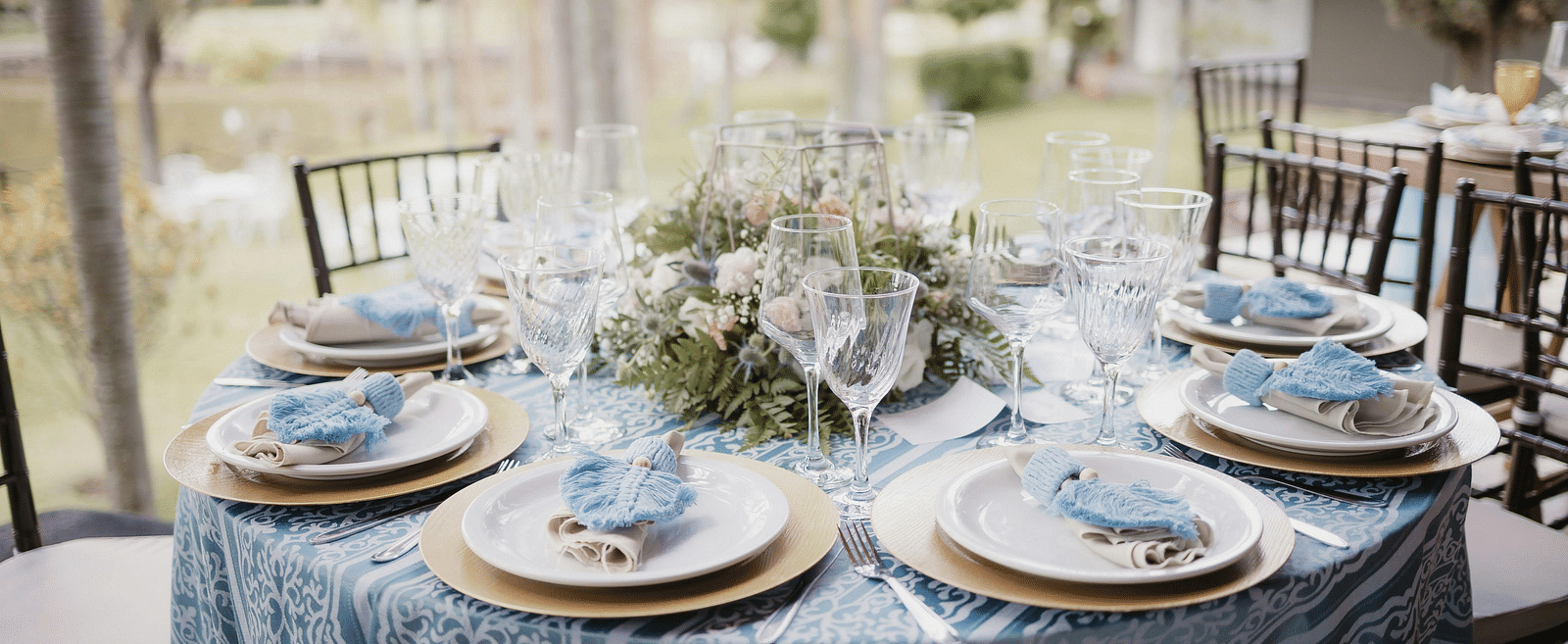 A beautifully arranged table and chairs, adorned for an event.