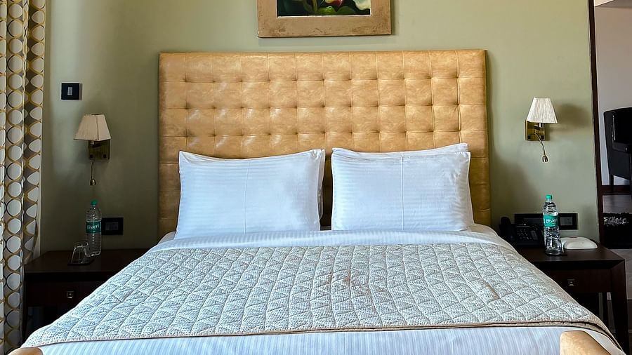 Bright bedroom with tufted headboard and chic wall art, offering peaceful vibes at Aranya Retreat, Mashobra