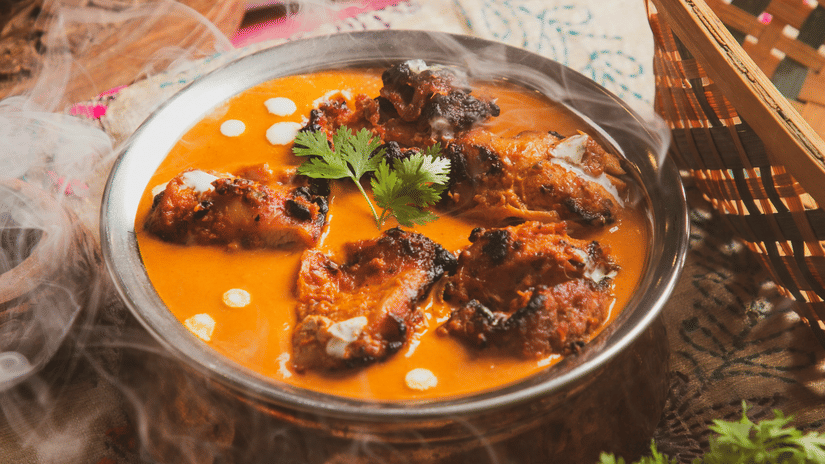 Traditional Indian curry served in a bowl with herbs and spices.