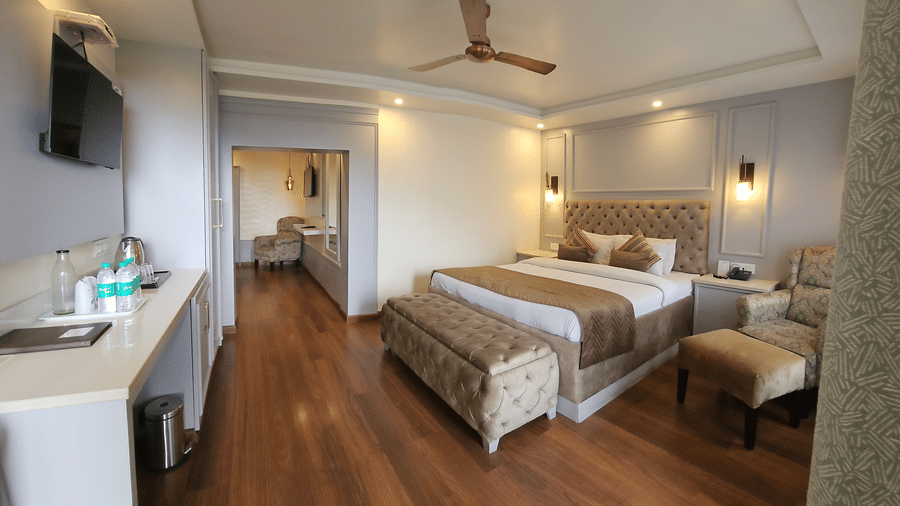 A Family Suite featuring a spacious bedroom with a plush bed and a wall-mounted TV | Mongas Hotel & Resort, Dalhousie