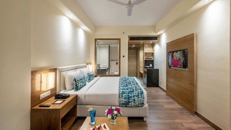 Bright Club room with double bed, clean walls, bedside table