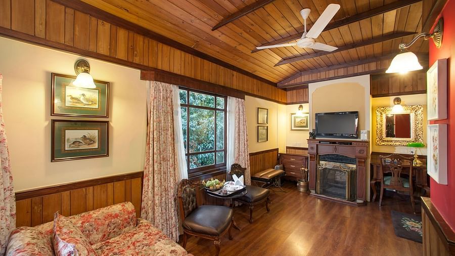the living room decked with a sofa set facing the TV - Mayfair Hill Resort, Darjeeling