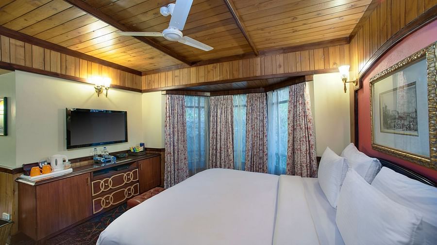 a king size bed facing the TV - Mayfair Hill Resort, Darjeeling 1