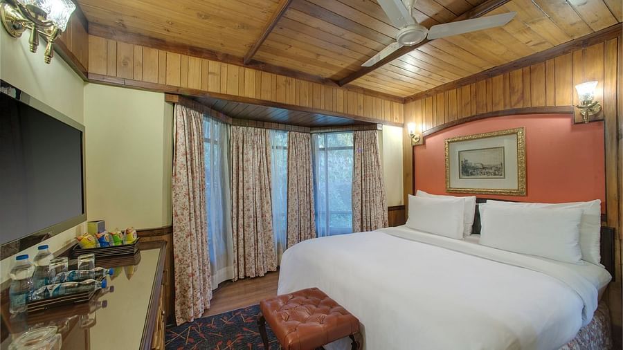 a king size bed facing the TV - Mayfair Hill Resort, Darjeeling 1