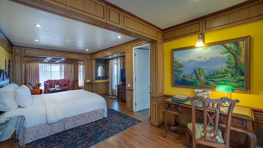 a king size bed and a workstation offered at the suite - Mayfair Hill Resort, Darjeeling