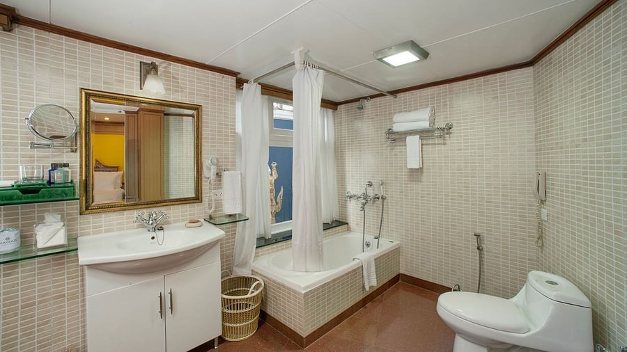 bathroom decked with a wash basin, a cabinet and a bathtub - Mayfair Hill Resort, Darjeeling
