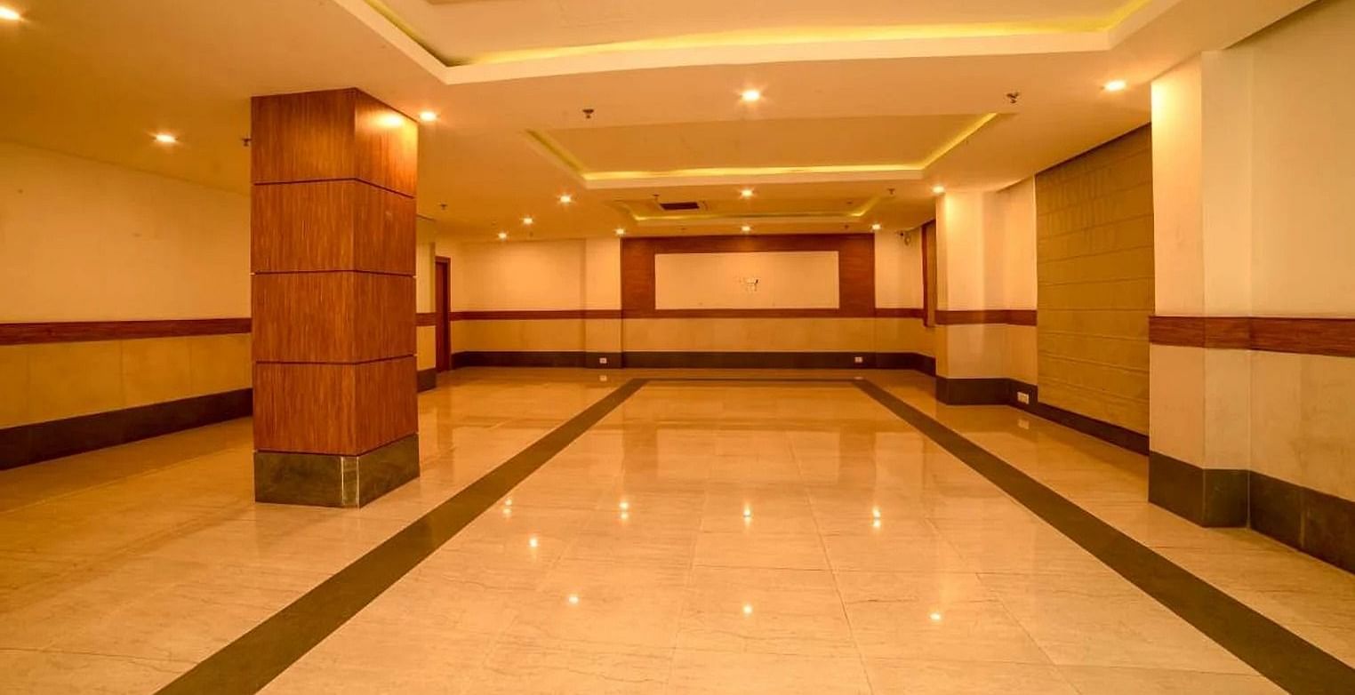 full view image of the spacious banquet hall with white tile flooring - Max Hotel, Jabalpur