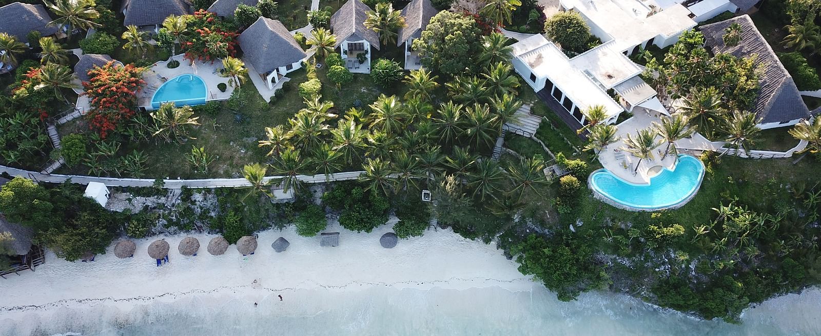 Top View of Shooting Star boutique hotel surrounded by trees on one side and ocean on other side.JPG