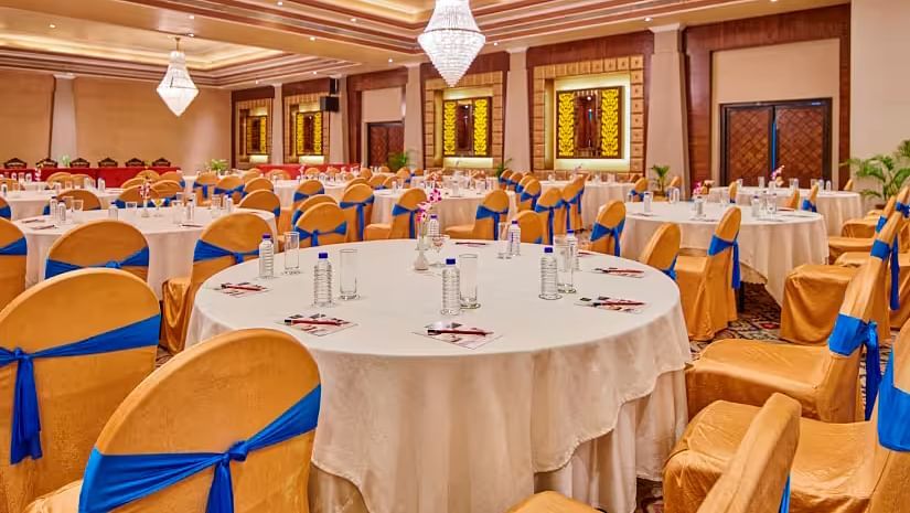 Event area with tables and chairs, and the hall decorated for a celebration.