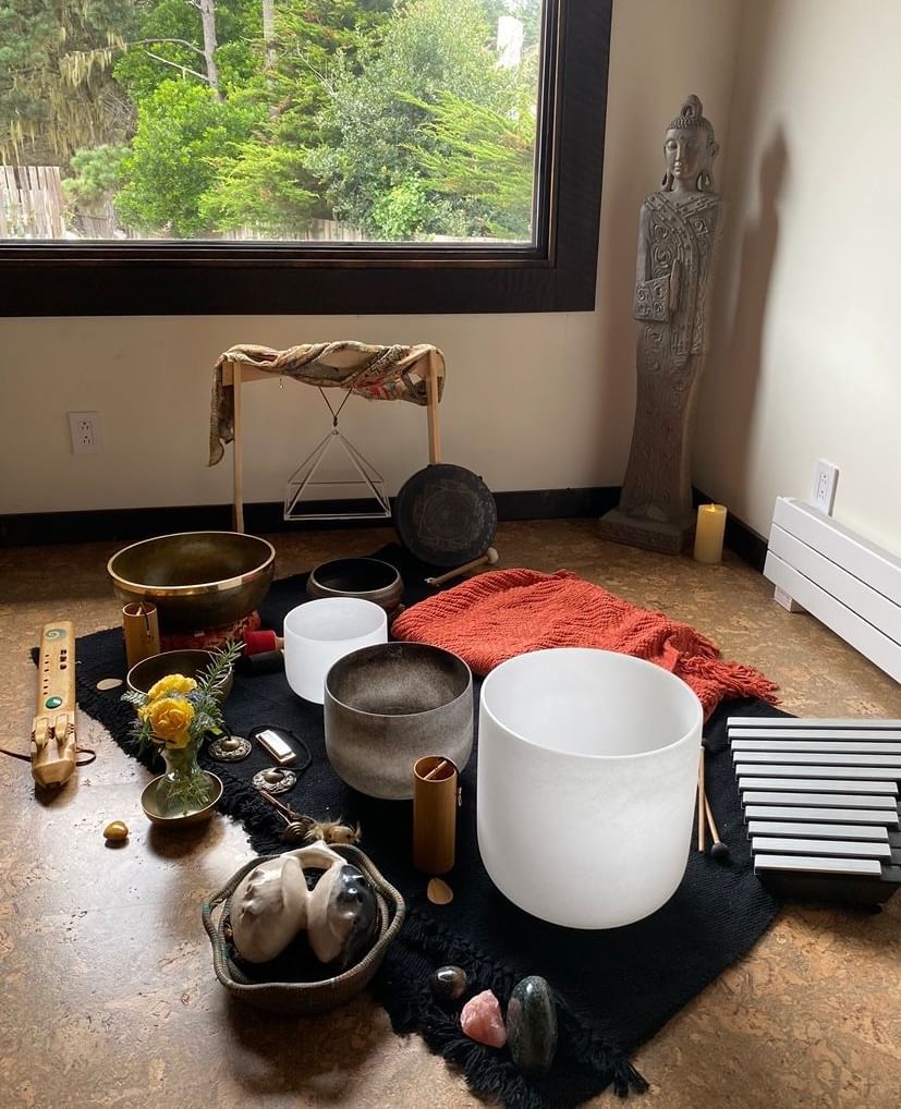 Sound healing instruments arranged by a window for a wellness session
