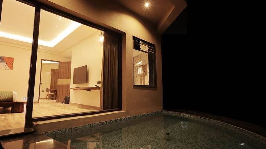 Luxury Villa with Plunge Pool with modern outdoor area includes a small, dark pool reflecting the building's lights, surrounded by sleek, contemporary architecture at The Qualia Resort Club & Brewery, Udaipur.