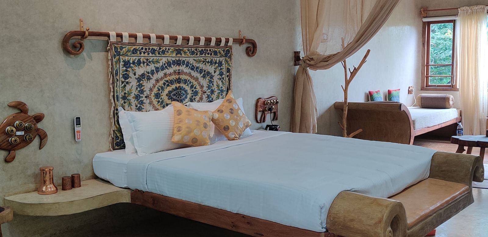 Close up view of the bed in snapper room with beautiful seating space attached to the bed, and contemporary beddings make the room pleasing and opulent.