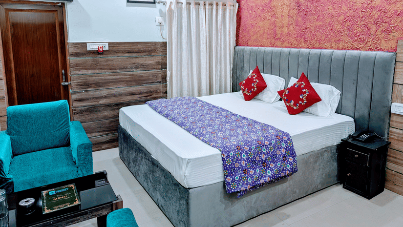 An image of a Standard Double Bed Room featuring a bed, a seating area and a wardrobe at Rangamati Garden Resort