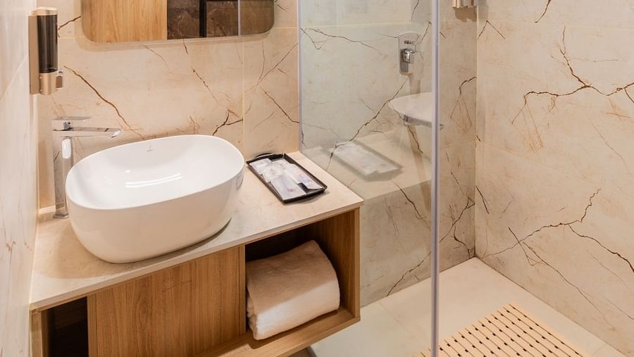 Washbasin and mirror in The Premium Rooms at Livancia The Sojourn, Bangalore.