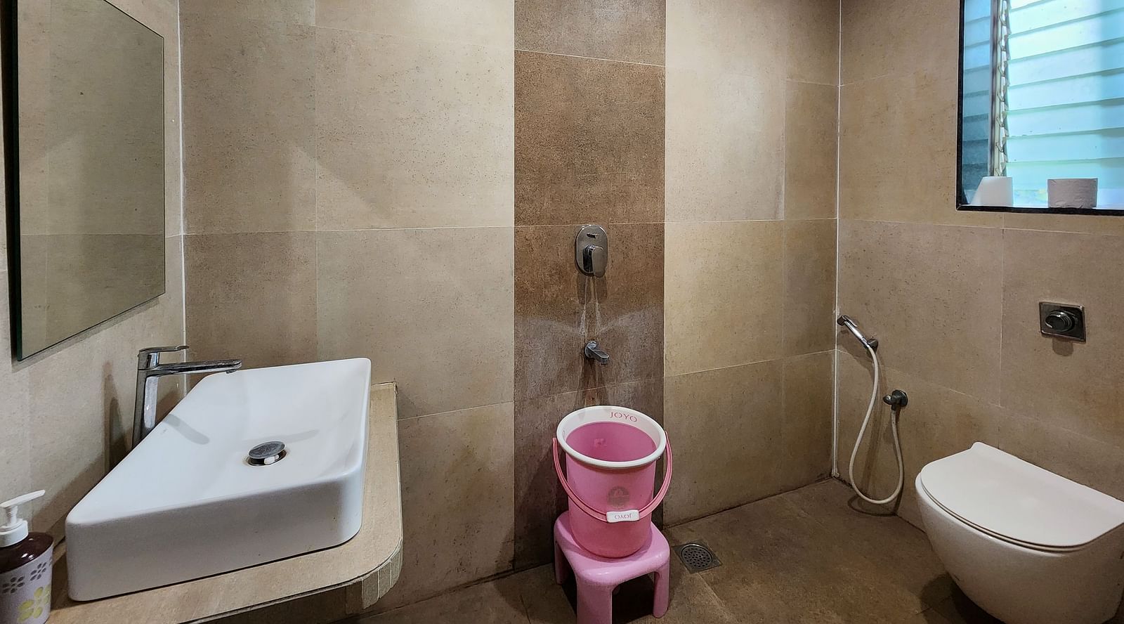 Bathroom of Premium Room at The Kanila Resort featuring a toilet, sink area and a bucket.
