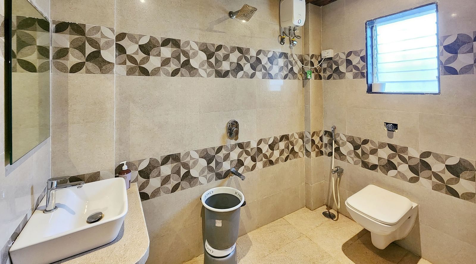Bathroom of Triple Premium Room at The Kanila Resort featuring a toilet, sink area and a bucket.