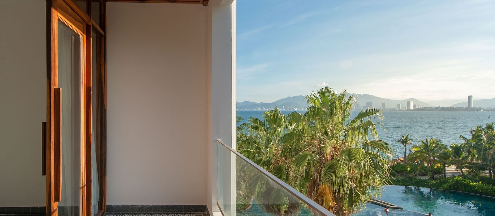 A balcony in one of the room with a sliding glass door - Alibu Resort Nha Trang