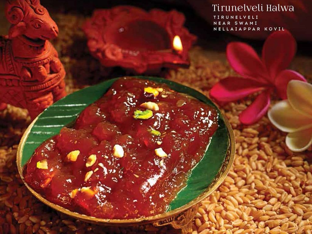 Spicy Indian curry served in a green bowl with floral decorations.
