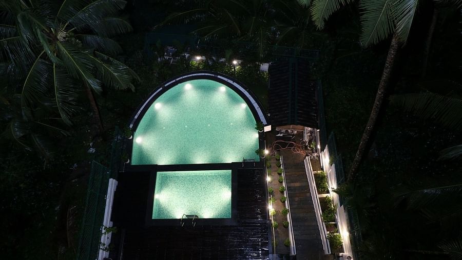  A dark, atmospheric image of an outdoor area at night, possibly a pathway or entrance, with subtle lighting illuminating an archway or structure - Sea Hills Hotels, Sri Vijaya Puram (Port Blair)