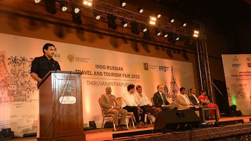 People sitting on the stage while one person is giving speech at the main hall at Uday Palace Convention Centre