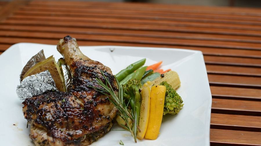 Herbs roast chicken served with jacket potato sautéed vegetables and black pepper sauce 1