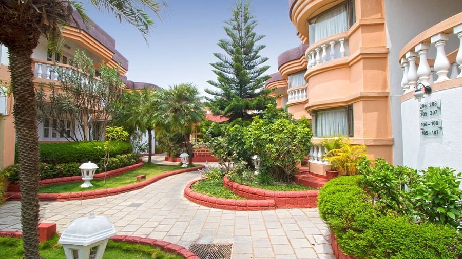 Facade  Lotus Eco Beach Resort konark and surrounded by green plants and trees.