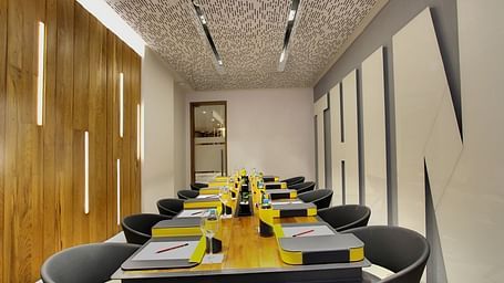 Intimate dining room with a long table and contemporary decor at GRT Hotels