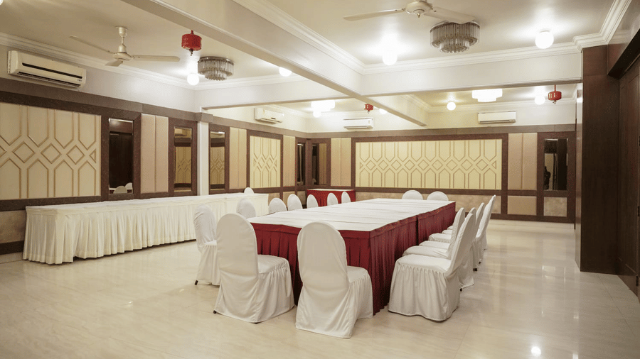 A conference room displays a neatly arranged table at Diamond Hotel Varanasi.