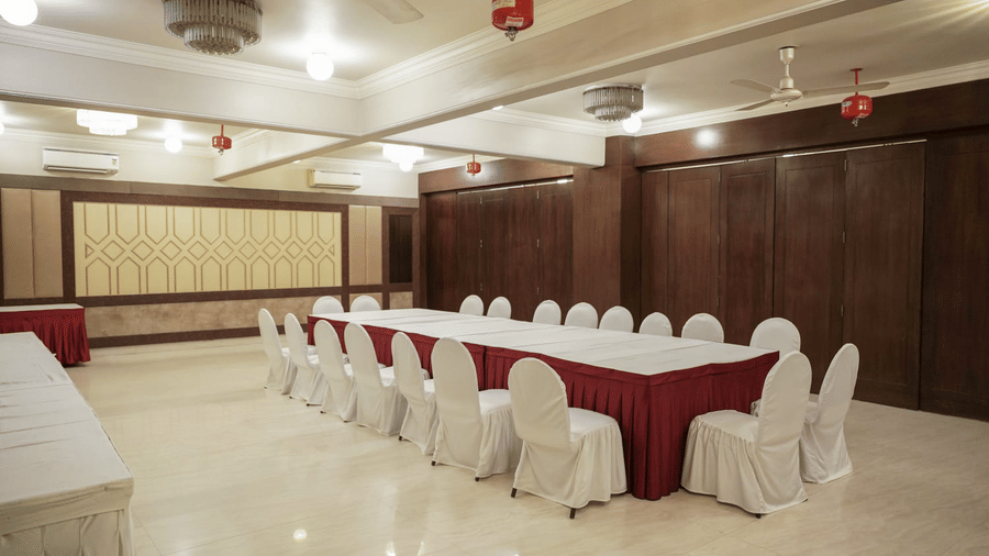 A spacious banquet hall is ready for an event at Diamond Hotel Varanasi.