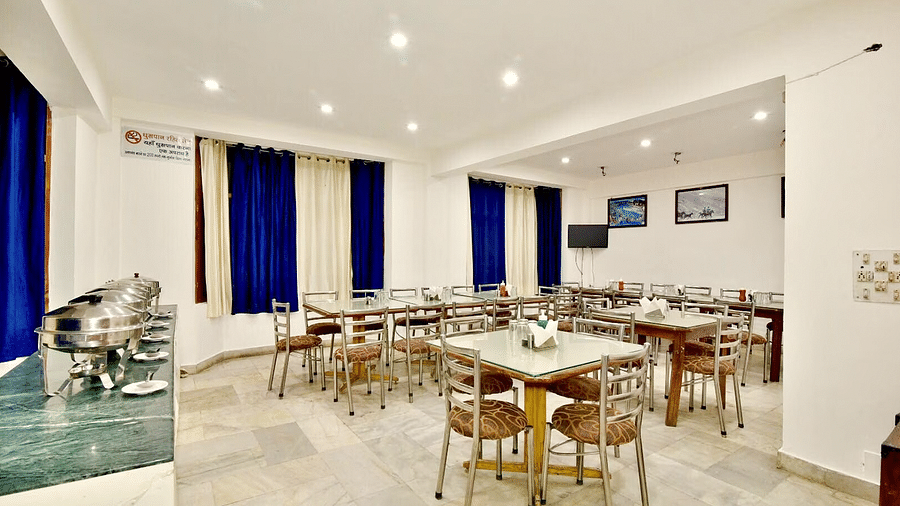 Well-lit interiors of the restaurant at DLS Hotel Devlok, Manali with the buffet arrangement towards the side