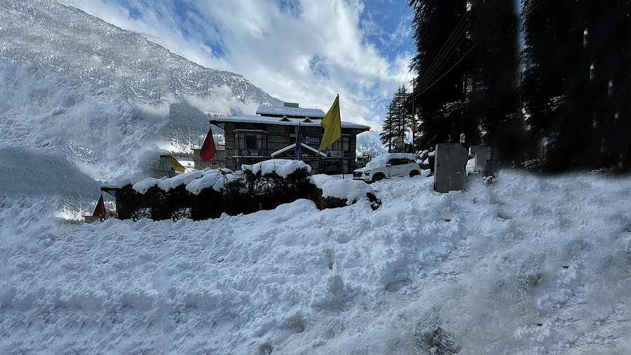 A wide view of the exterior of DLS Hotel Devlok, Manali during winters, covered in snow