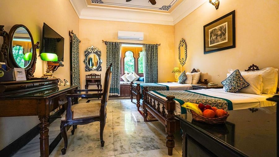 A well-appointed hotel room featuring a large bed, a daybed, and elegant furnishings - Khas Bagh, Jaipur.