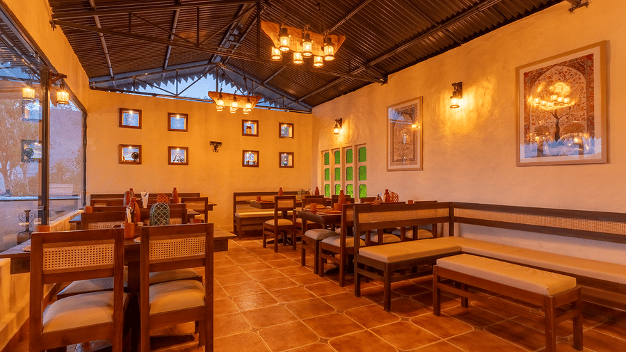 Cosy indoor restaurant area with wooden furniture and warm ambient lighting at Maati Resort By The Lake Hill, Jeolikote.