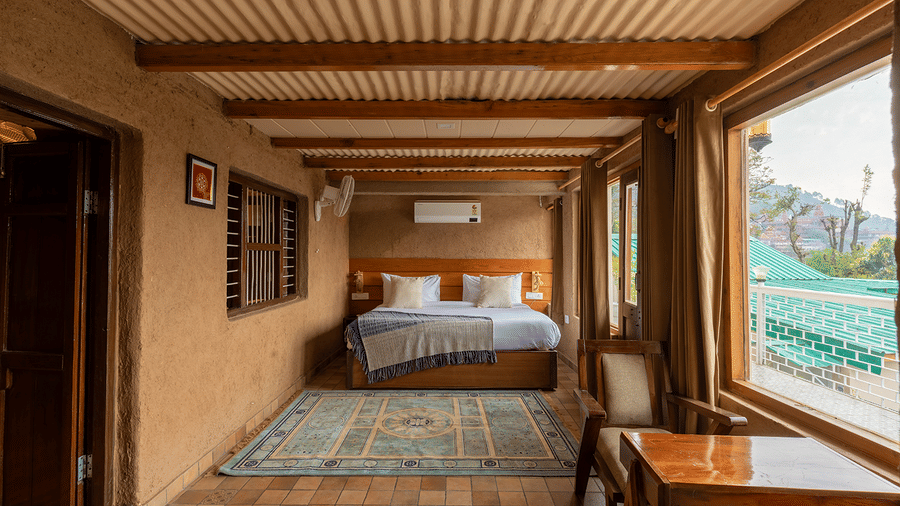 Large open-plan suite showcasing the fusion of rustic architecture and modern comfort at Maati Resort By The Lake Hill, Jeolikote.