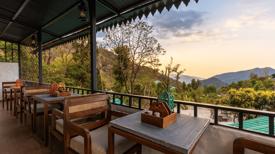 Outdoor balcony seating with a stunning view of the Jeolikote mountains at Maati Resort By The Lake Hill, Jeolikote.